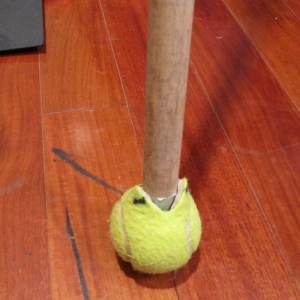 A tennis ball on a broom handle